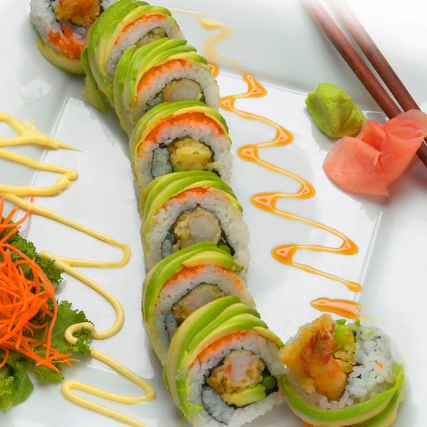MAJÉ Sushi's avocado-wrapped sushi rolls with shrimp tempura, roe, sauces, wasabi, and ginger.